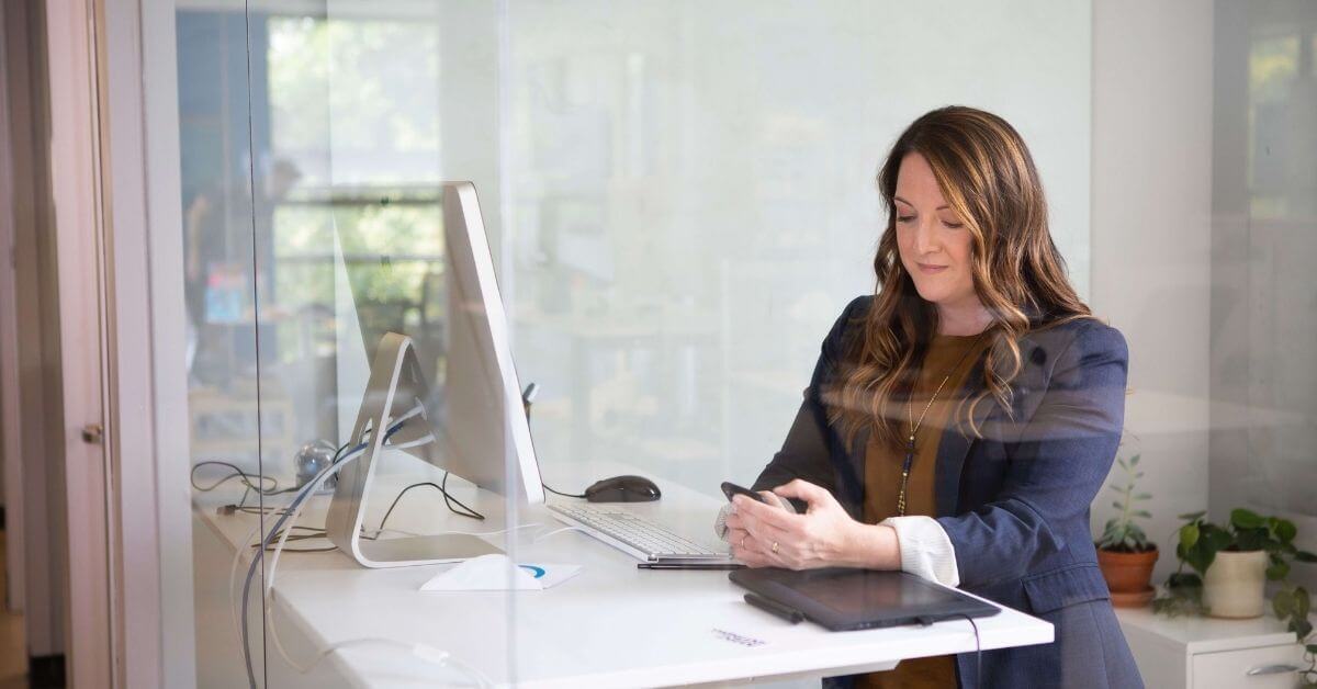 woman at her desk on her phone