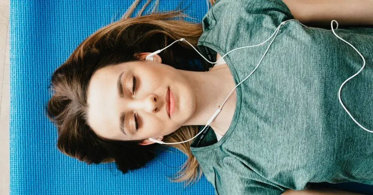 woman laying down with headphones in